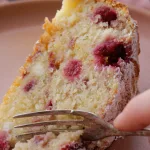 Slice of Raspberry ricotta cake being cut with fork
