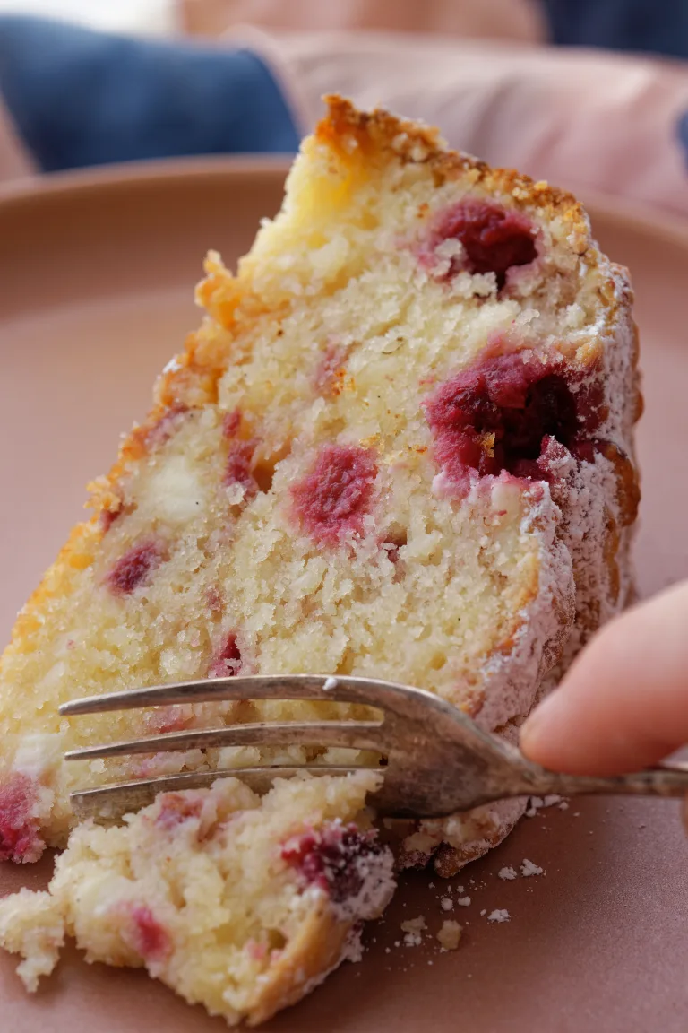 Slice of Raspberry ricotta cake being cut with fork