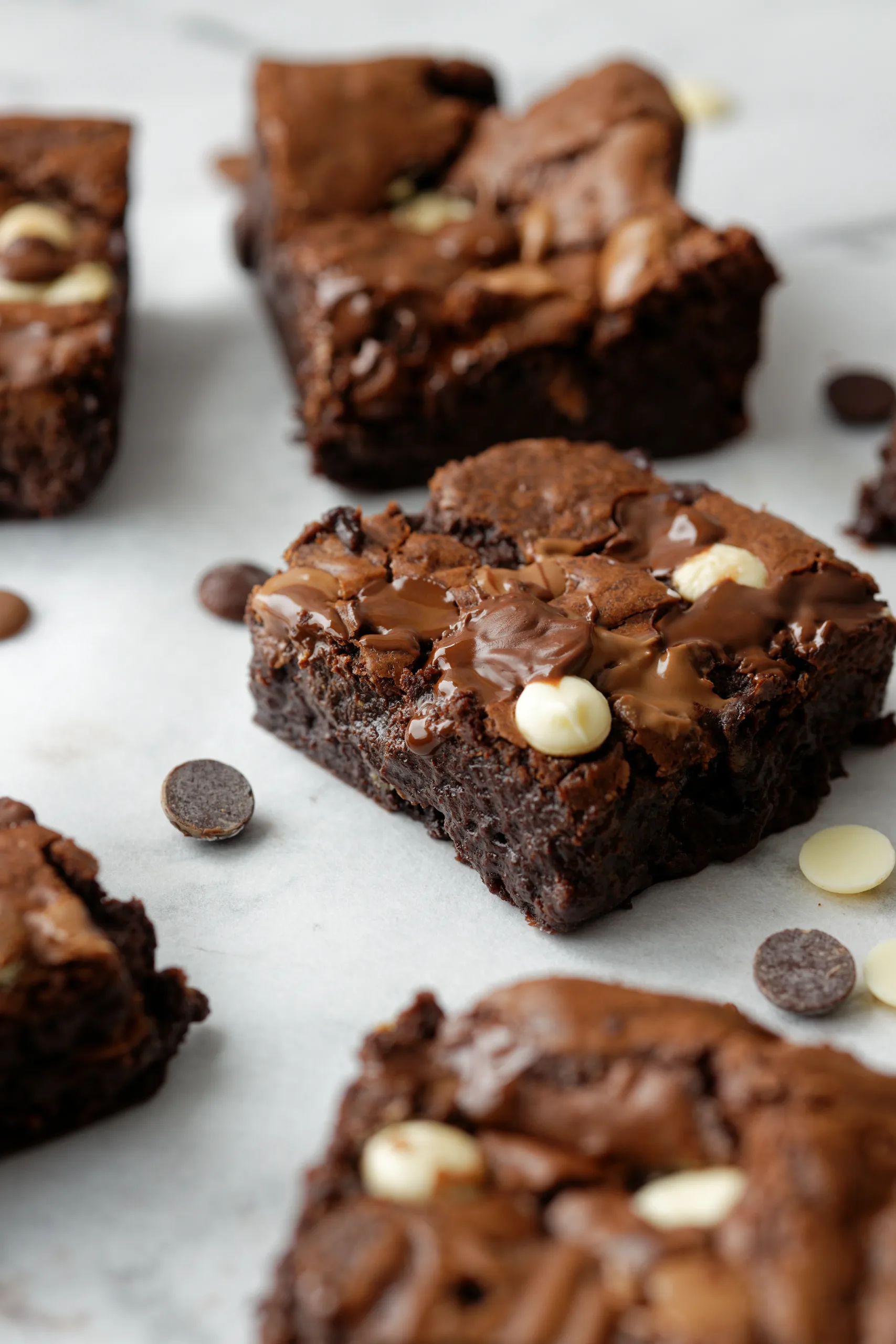 Brownie squares on baking paper with scattered choc chips
