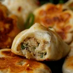Stack of dumplings showing filling.