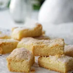 Stack of shortbread biscuits on wooden plate