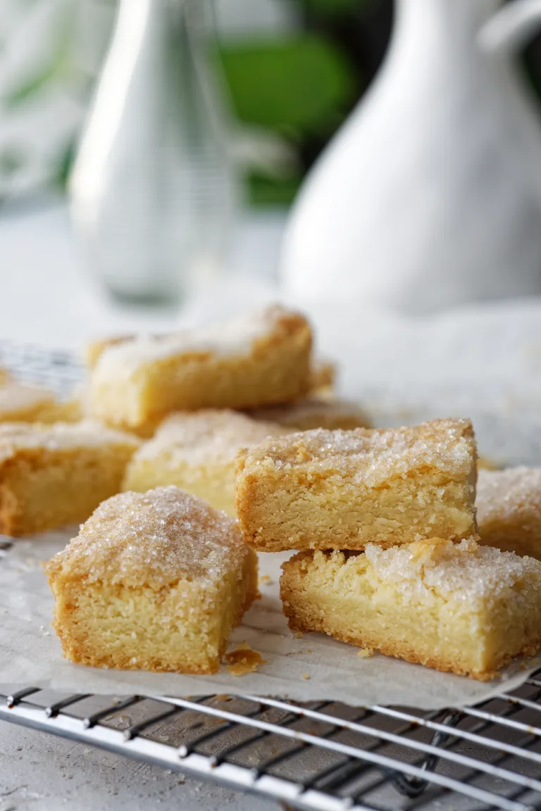 Stack of shortbread biscuits on wooden plate