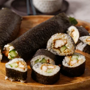 sliced sushi stacked on wooden plate