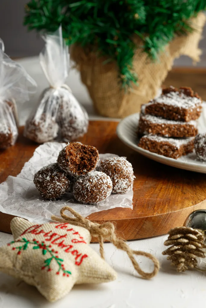 Rum balls on wooden platter with christmas background