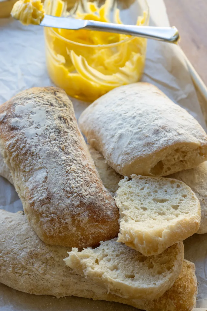 bread roll with butter bowl in background