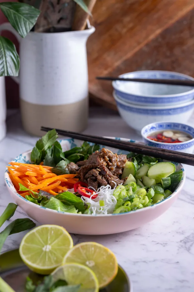 Kitchen with marble benchtop with bowl of Vietnamese noodle salad