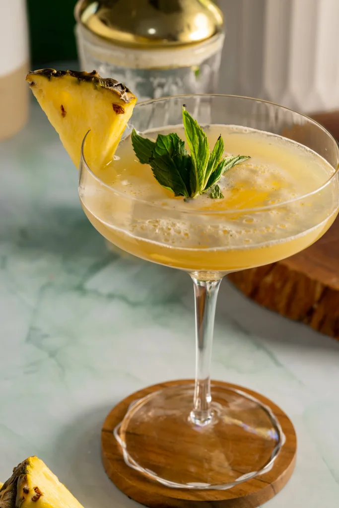 Mocktail with pineapple and mint garnish