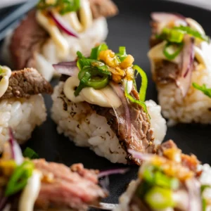 Beef carpaccio sushi pieces on grey plate