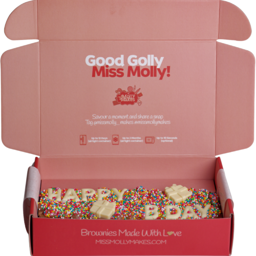 Brownie half slab with 'HAPPY BDAY' in white chocolate letters and sprinkles