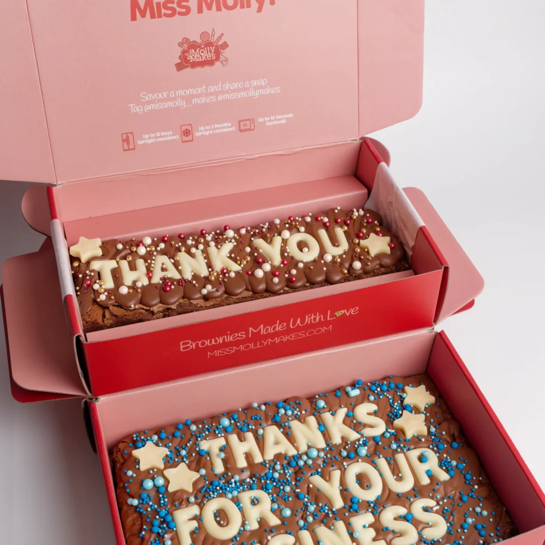 Two open gift boxes holding brownie slabs spelling 'Thank You' and 'Thanks For Your Business'