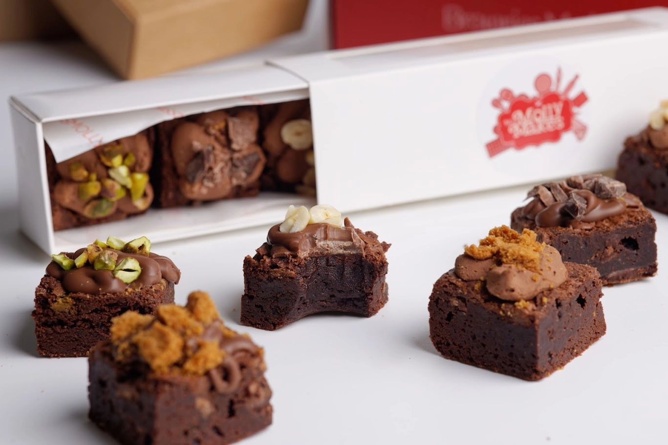 MissMollyMakes branded corporate brownie bites sitting alongside a white gift box