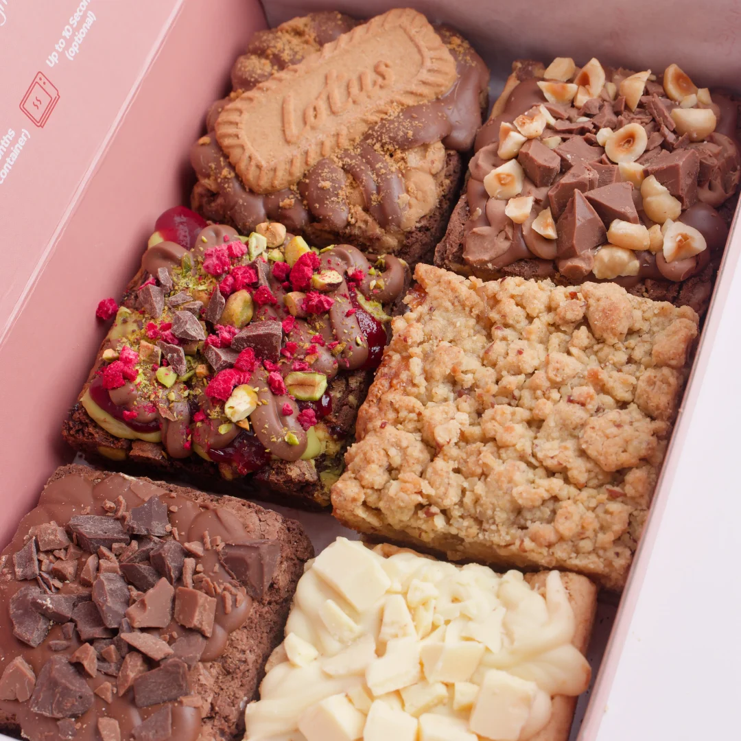 Six loaded brownies topped with Lotus biscuit, raspberry, white chocolate and hazelnut