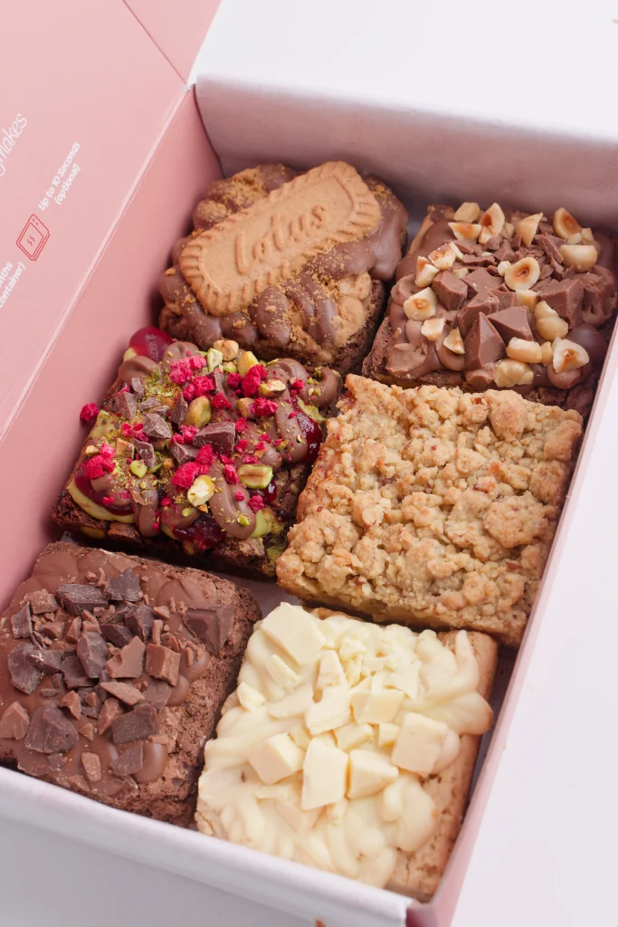 Six loaded brownies topped with Lotus biscuit, raspberry, white chocolate and hazelnut